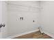 A laundry room with vinyl floors, utility connections, and a shelf for storage at 236 Arbor Creek Dr, Dallas, GA 30157