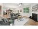 Open-concept living space with hardwood floors, a fireplace, and a view into the kitchen and dining area at 236 Arbor Creek Dr, Dallas, GA 30157