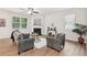 Bright and airy living room featuring hardwood floors, stylish furnishings, and a cozy fireplace at 236 Arbor Creek Dr, Dallas, GA 30157