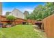 Well-manicured backyard with a wooden fence, lush greenery, and mature trees at 3573 Willow Tree Trce, Decatur, GA 30034