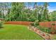 Lush backyard with a vibrant lawn, mature trees, and wooden fence providing privacy at 3573 Willow Tree Trce, Decatur, GA 30034