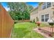 Serene backyard featuring a lush lawn and a charming fence, perfect for outdoor enjoyment and privacy at 3573 Willow Tree Trce, Decatur, GA 30034