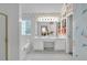 Elegant bathroom featuring dual sinks, a large mirror, floral wallpaper, and a soaking tub for relaxation at 3573 Willow Tree Trce, Decatur, GA 30034