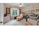 Bright bedroom featuring a cozy sitting area by the window and built-in shelving for added functionality at 3573 Willow Tree Trce, Decatur, GA 30034