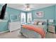 Charming bedroom with a ceiling fan, bright blue walls, and a comfortable bed, creating a cozy retreat at 3573 Willow Tree Trce, Decatur, GA 30034