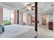Primary bedroom suite with canopy bed, sitting area, and lots of natural light at 3573 Willow Tree Trce, Decatur, GA 30034