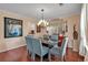 Elegant dining room with a modern chandelier, a glass table, and seating for six at 3573 Willow Tree Trce, Decatur, GA 30034