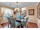 Stylish dining area with modern furniture, hardwood floors, and a view into the foyer at 3573 Willow Tree Trce, Decatur, GA 30034