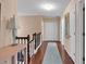 Upstairs hallway with gleaming hardwood floors and natural light, leading to multiple rooms with neutral paint at 3573 Willow Tree Trce, Decatur, GA 30034