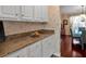 Kitchen details include white cabinetry with wooden knobs and tan granite countertops at 3573 Willow Tree Trce, Decatur, GA 30034