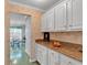 Kitchen featuring granite counters and white cabinetry at 3573 Willow Tree Trce, Decatur, GA 30034