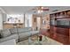 Open-concept living area with a cozy sofa, a modern TV unit, and views into the kitchen at 3573 Willow Tree Trce, Decatur, GA 30034
