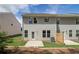 Exterior view of back of house with a grassy yard, concrete patio, and light gray siding at 389 Navigator Ln, Mcdonough, GA 30253