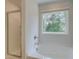 Bathroom featuring a tub, separate shower, and window with a view of mature trees at 389 Navigator Ln, Mcdonough, GA 30253