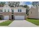 New townhome featuring brick and siding, complemented by a manicured lawn at 389 Navigator Ln, Mcdonough, GA 30253