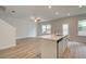 Open-concept living space with wood floors, a ceiling fan, and plenty of natural light at 389 Navigator Ln, Mcdonough, GA 30253