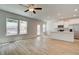 Open-concept living space with light wood floors and plenty of natural light at 389 Navigator Ln, Mcdonough, GA 30253