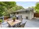 Outdoor back deck with table, chairs, grill, and backyard view at 1060 Pinedale Se Dr, Smyrna, GA 30080