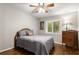 Bedroom with a bed, dresser, wood floors, ceiling fan, and natural light from the window at 1060 Pinedale Se Dr, Smyrna, GA 30080