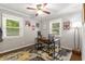 Bedroom with wood floors, ceiling fan, windows with blinds, desk and office chair at 1060 Pinedale Se Dr, Smyrna, GA 30080