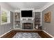 Inviting living room featuring a fireplace, built-in shelving, and hardwood floors at 1060 Pinedale Se Dr, Smyrna, GA 30080