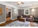 Comfortable living room with hardwood floors, brick wall, and access to the kitchen at 1060 Pinedale Se Dr, Smyrna, GA 30080