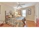 Comfortable bedroom with hardwood floors, ceiling fan, and natural light from the window at 2000 Kristian Way, Roswell, GA 30076