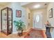 Inviting entryway with hardwood floors, decorative lighting, and a charming display cabinet with decorative plant at 2000 Kristian Way, Roswell, GA 30076