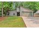Charming single-story home with neutral siding, attached garage, and well-manicured lawn surrounded by mature trees at 2000 Kristian Way, Roswell, GA 30076