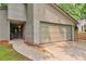 Close up of the attached two-car garage, entry way and front facade of a lovely suburban home at 2000 Kristian Way, Roswell, GA 30076