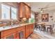 Eat-in kitchen with stainless steel sink, custom cabinetry, granite countertops, and tiled backsplash at 2000 Kristian Way, Roswell, GA 30076