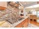 Gourmet kitchen features a gas range, granite countertops, and a view into the dining and living areas at 2000 Kristian Way, Roswell, GA 30076