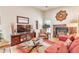 Inviting living room features a cozy fireplace, hardwood floors, comfortable seating, and natural light at 2000 Kristian Way, Roswell, GA 30076