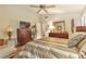 Relaxing main bedroom featuring a bed, dressers, television, ceiling fan, and comfortable furniture at 2000 Kristian Way, Roswell, GA 30076