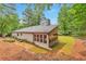 View of the backside of the home which features a beautiful sunroom, large backyard, and privacy at 2000 Kristian Way, Roswell, GA 30076