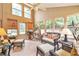 Bright sunroom with wicker furniture, tile flooring, and plenty of natural light at 2000 Kristian Way, Roswell, GA 30076