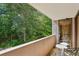 Balcony with outdoor seating offers a tranquil view of lush greenery, perfect for relaxation at 3530 Piedmont Ne Rd # 2I, Atlanta, GA 30305