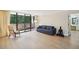 Spacious living room featuring a wall of windows and light, wood-look floors at 3530 Piedmont Ne Rd # 2I, Atlanta, GA 30305