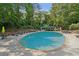 Resort-style outdoor pool surrounded by lounge chairs and lush landscaping at 3530 Piedmont Ne Rd # 2I, Atlanta, GA 30305