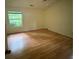 Bright and airy bedroom with hardwood floors and a large window offering natural light at 425 Rockingham Ln, Woodstock, GA 30189