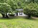 Charming single-story home with a well-manicured lawn and mature trees at 425 Rockingham Ln, Woodstock, GA 30189