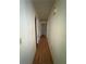 Hallway featuring neutral walls and hardwood flooring leading to various rooms at 425 Rockingham Ln, Woodstock, GA 30189