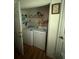 Laundry room featuring a washer, dryer, shelving and a clock on the wall at 425 Rockingham Ln, Woodstock, GA 30189