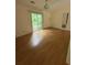 Bright living room featuring hardwood floors, sliding doors, and natural light at 425 Rockingham Ln, Woodstock, GA 30189