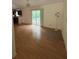 Open-concept living and dining area with sliding glass doors and hardwood flooring at 425 Rockingham Ln, Woodstock, GA 30189