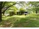 Sprawling backyard featuring lush greenery and a charming screened-in porch, ideal for relaxing outdoors at 1395 Clay Sw Rd, Mableton, GA 30126