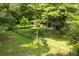 Expansive backyard with a couple of old sheds in view, enclosed by a chain-link fence and mature trees at 1395 Clay Sw Rd, Mableton, GA 30126