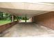 Spacious brick carport with a concrete floor and brick support pillars at 1395 Clay Sw Rd, Mableton, GA 30126