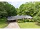 Charming home featuring a covered carport, lush greenery, and classic brick accents, offering curb appeal at 1395 Clay Sw Rd, Mableton, GA 30126