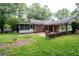 The back of the property featuring a screened-in porch and covered carport at 1395 Clay Sw Rd, Mableton, GA 30126